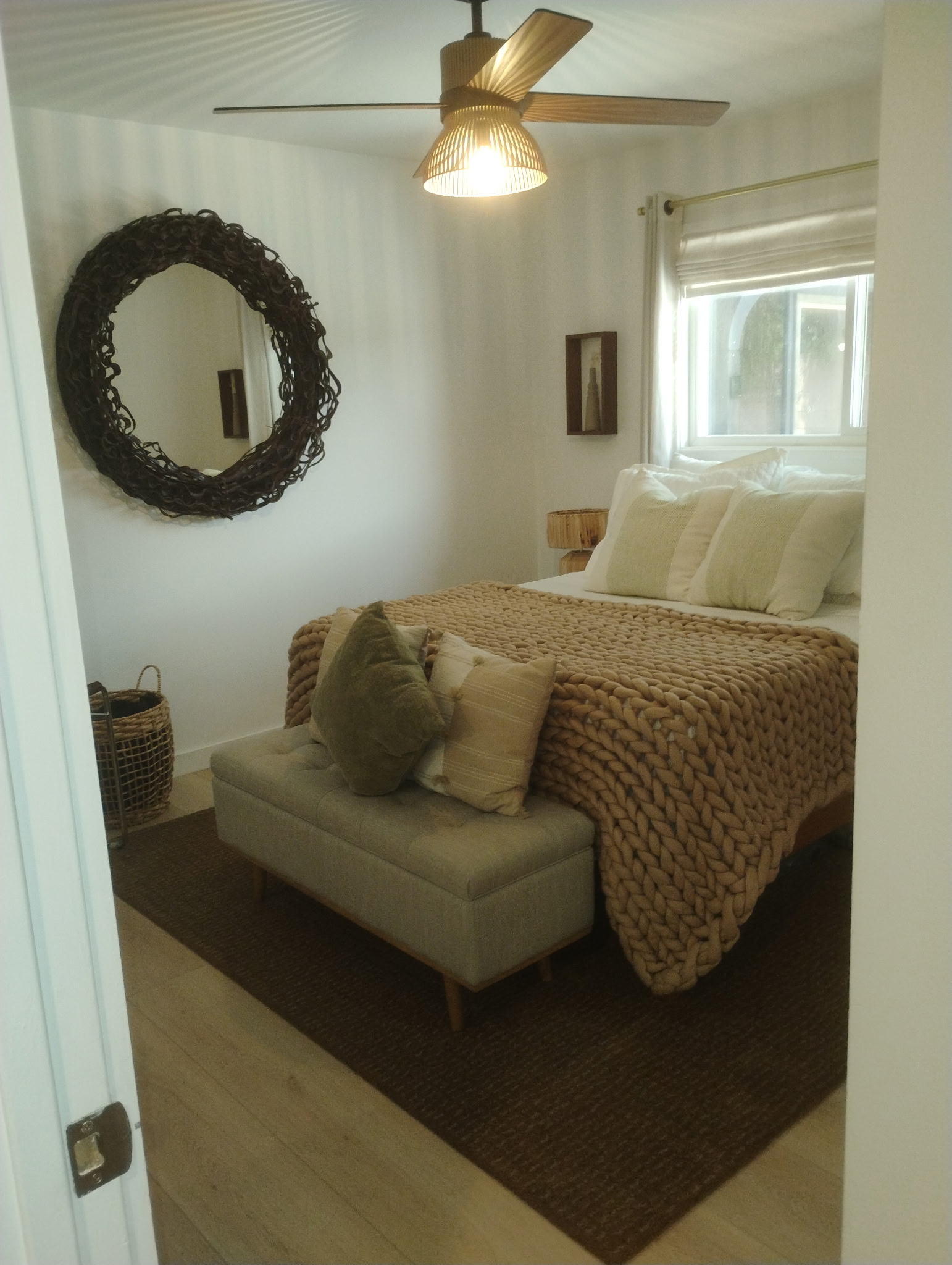 Freshly made bed in a bright bedroom